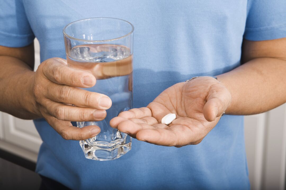 a man taking pills for parasites